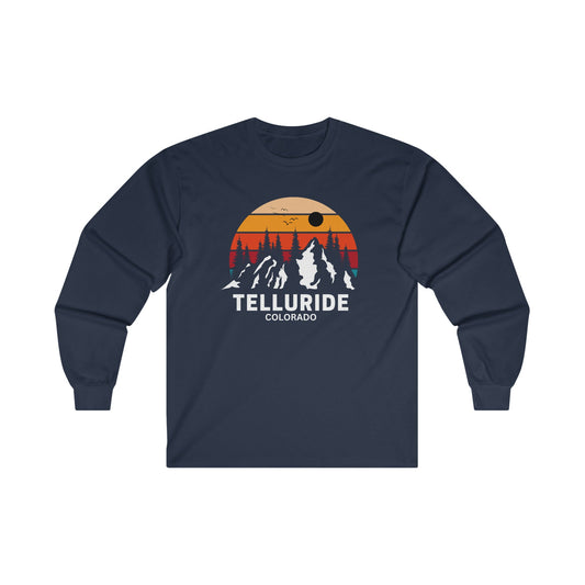 Long sleeve navy cotton unisex t-shirt with white lettering saying "Telluride Colorado". The t-shirt also has a colorful image of the mountains and a sunset in the background. The t-shirt is a stylish and comfortable way to show your love of skiing, hiking, and snowboarding at the Telluride Ski Resort.