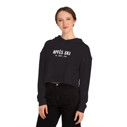 Black cropped hooded sweatshirt with white lettering saying "Après Ski" and "Telluride, CO." The sweatshirt is a stylish and comfortable way to show your love of skiing and the Telluride Ski Resort. The text is a reference to the French tradition of après-ski, which is a time to socialize and celebrate after a day on the slopes. 