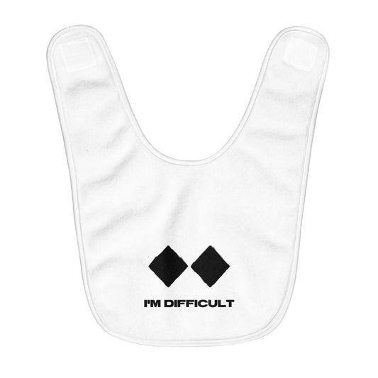 White fleece baby bib with black lettering saying "I'm Difficult" and two double diamond ski signs. The bib is made of soft, comfortable fleece and is perfect for keeping babies' clothes clean while they eat. The two double diamond ski signs are a reference to the most challenging ski runs at Telluride Ski Resort, making this bib a great way to show your support for the resort and the ski and snowboard lifestyle.