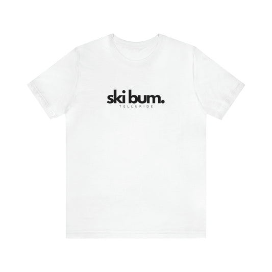White unisex short sleeve t-shirt with black lettering saying "Ski Bum" and Telluride. The t-shirt is made of 100% cotton and is perfect for a day of skiing or snowboarding. The phrase "Ski Bum" is a popular term for someone who loves to ski or snowboard and who lives or spends a lot of time in a ski resort town. This t-shirt is a great way to show your love of skiing and snowboarding, and your love of the Telluride Ski Resort.