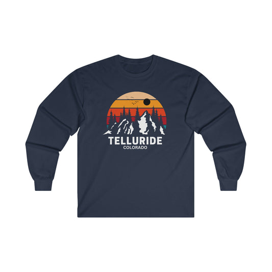 Long sleeve navy cotton unisex t-shirt with white lettering saying "Telluride Colorado". The t-shirt also has a colorful image of the mountains and a sunset in the background. The t-shirt is a stylish and comfortable way to show your love of skiing, hiking, and snowboarding at the Telluride Ski Resort. 