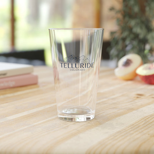 16oz pint glass with blue lettering saying "Telluride Colorado" and a mountain range in the background. The glass is a stylish and practical way to enjoy a cold beverage while celebrating your love of the Telluride Ski Resort and Colorado whether you're enjoying a drink at home after a long day of skiing, hiking, snowboarding or shopping.