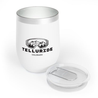 White 12oz stainless steel drink tumbler with black lettering saying "Telluride Colorado" and a mountain range printed inside of ski or snowboard goggles. The tumbler is a stylish and practical way to keep your drinks cold or hot while celebrating your love of skiing, hiking, snowboarding and shopping at the Telluride Ski Resort. 