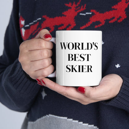 White ceramic coffee cup with black lettering saying "World's Best Skier." The cup is perfect for a morning coffee boost for any skier who loves to claim the title of the best. The text is a playful way to celebrate your love of skiing and your skills on the slopes at the Telluride Ski Resort.